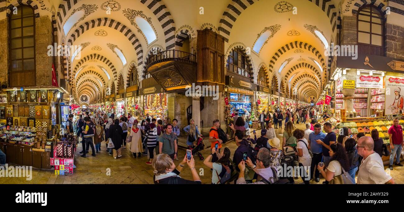 Panoramic view of the interior disign of Spice Bazaar, Mısır Çarşısı, also known as Egyptian Bazaar, many people are walking and shopping inside Stock Photo