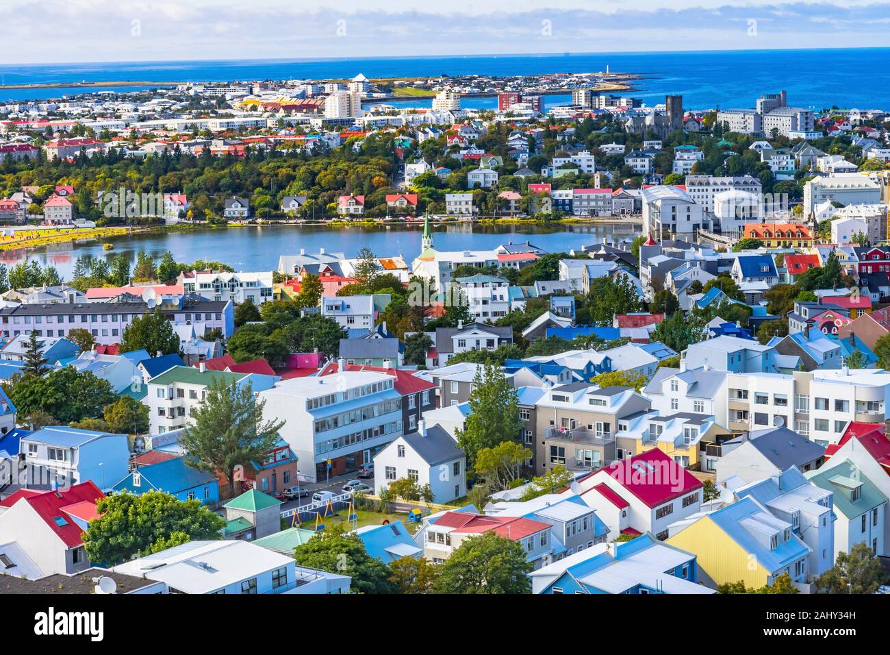 Small Tjornin Lake Blue Ocean Sea Colorful Blue Red White Green Houses Streets Reykjavik Iceland. Stock Photo