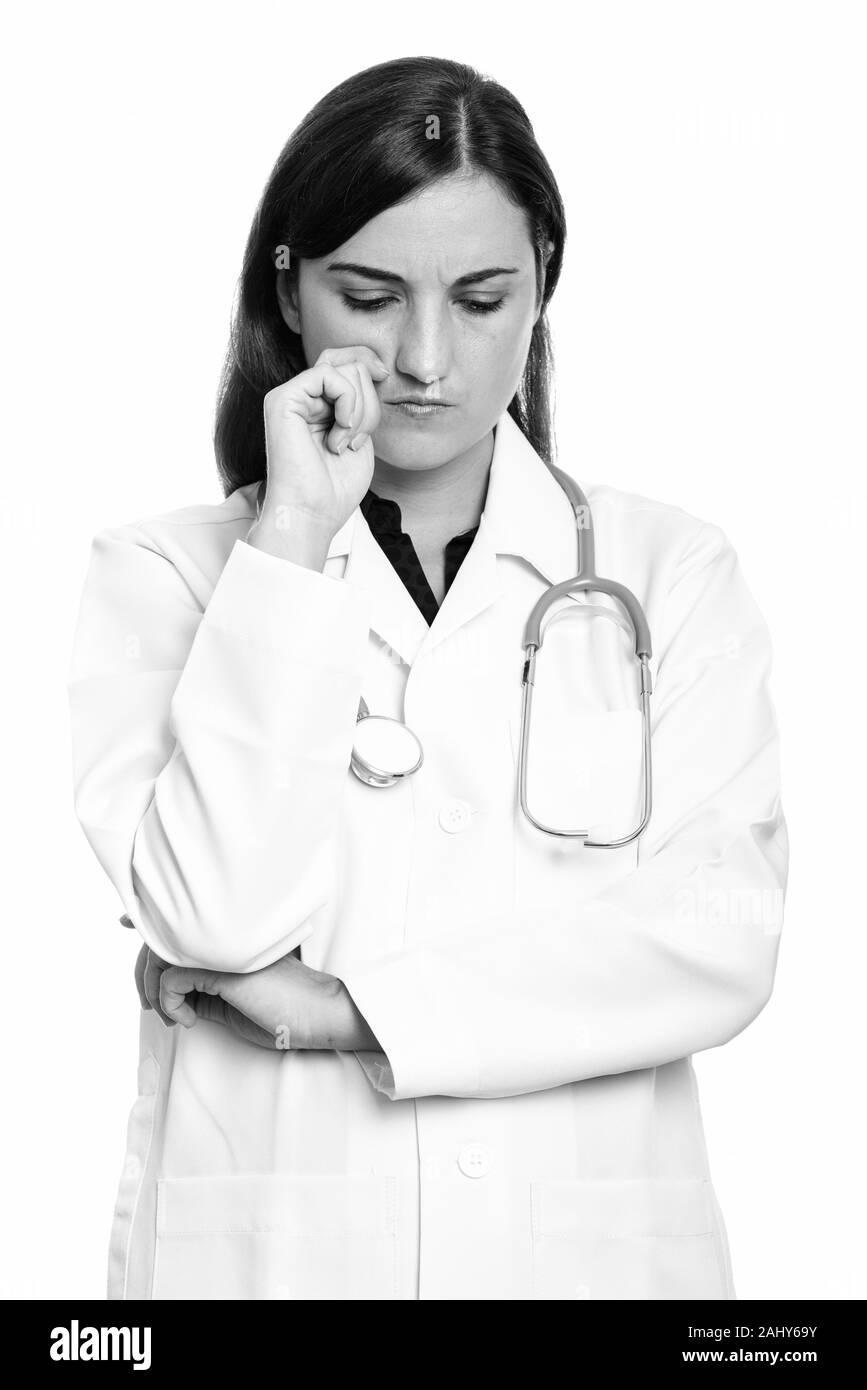 Studio shot of sad woman doctor thinking in black and white Stock Photo