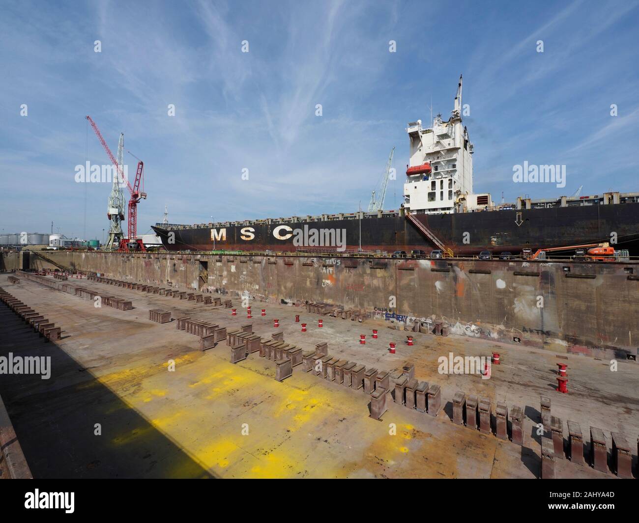 Large ship next to a dry dock in the port of Antwerp, Belgium Stock Photo