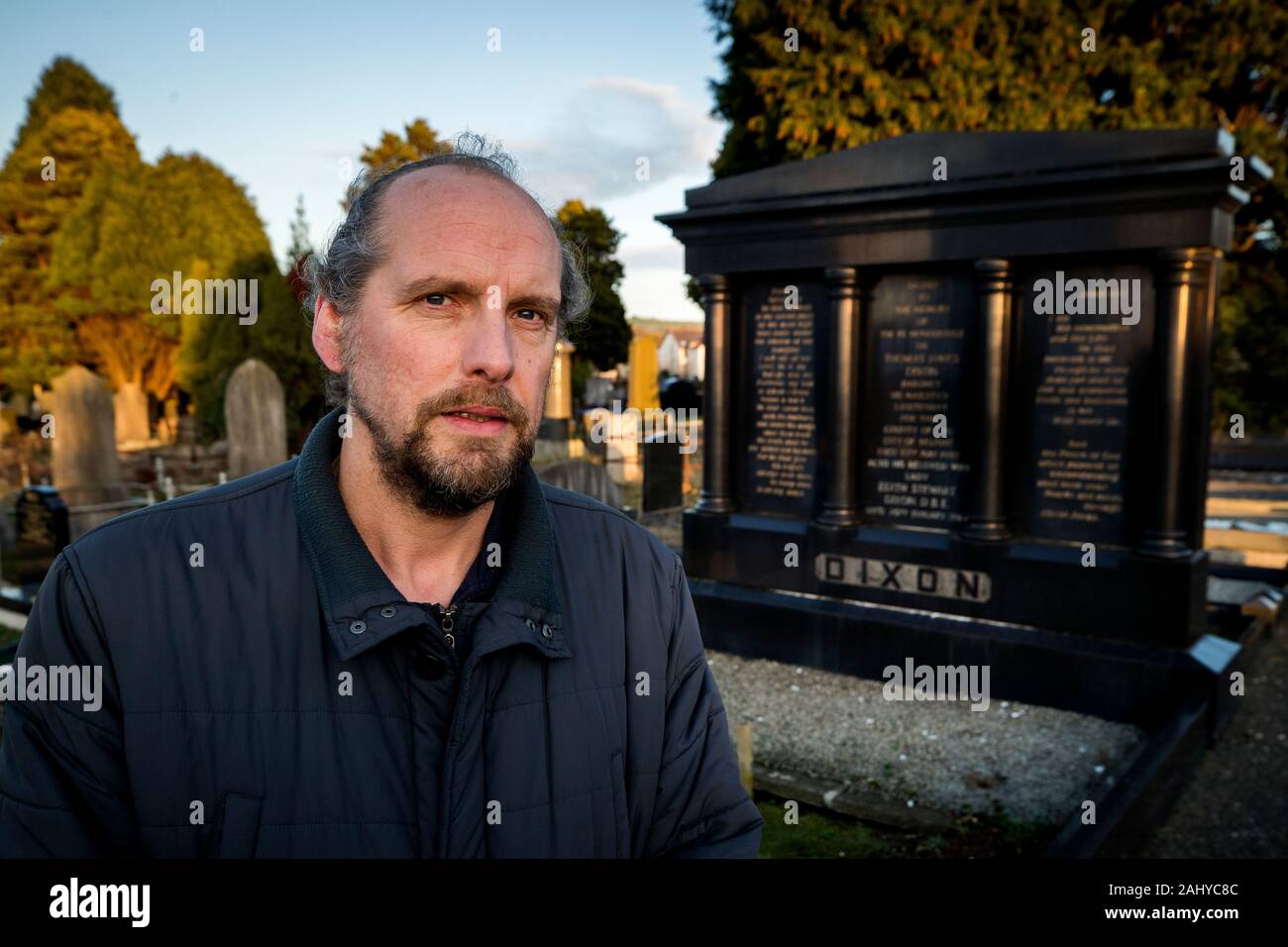 Peter McCabe next to the grave of Sir Thomas & Lady Dixon at Dundonald Cemetery in Belfast, he has unearthed a host of fascinating facts about those who are interred in the east Belfast burial ground of the famous and infamous in his new book. Stock Photo