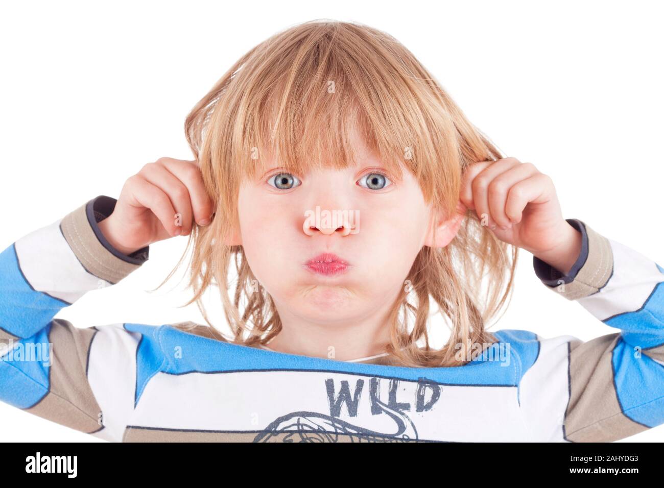 boy with long blond hair pulling his ears, looking - isolated on white Stock Photo