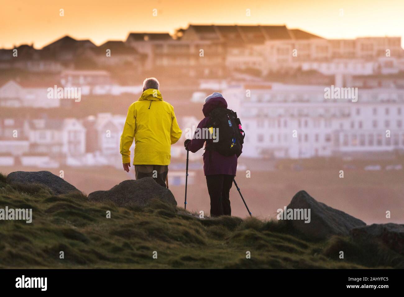Walkers on the coastal path at Fistral in Newquay Cornwall. Stock Photo