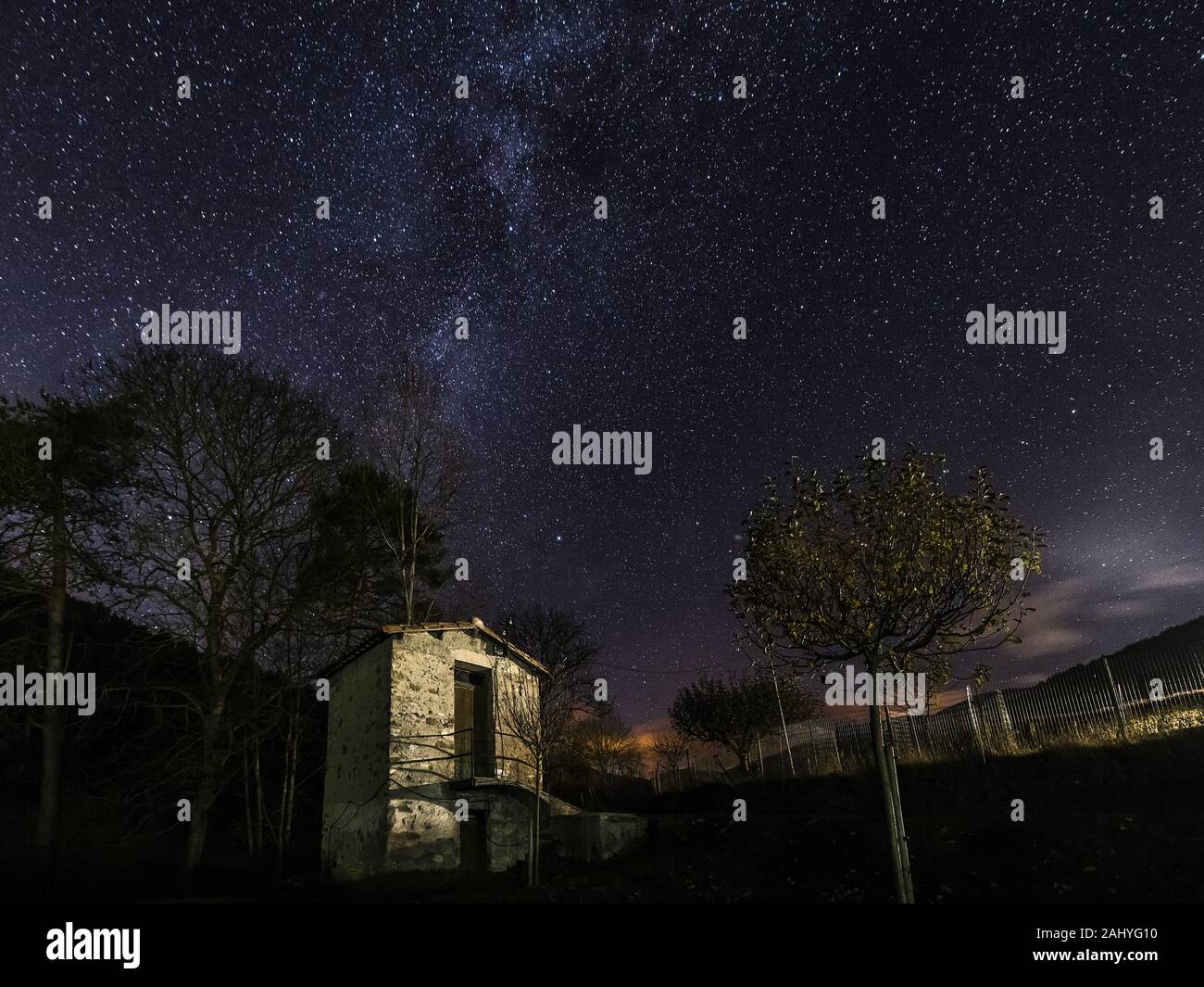 wonderful starry night sky with the Milky Way over a farmhouse small ...