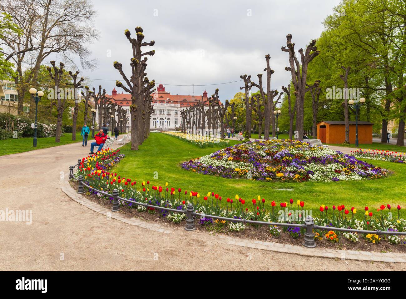 Karlovy Vary, Czech Republic - May 5, 2017: People walk in Zahrada park at cloudy spring day. Smetanovy sady Stock Photo