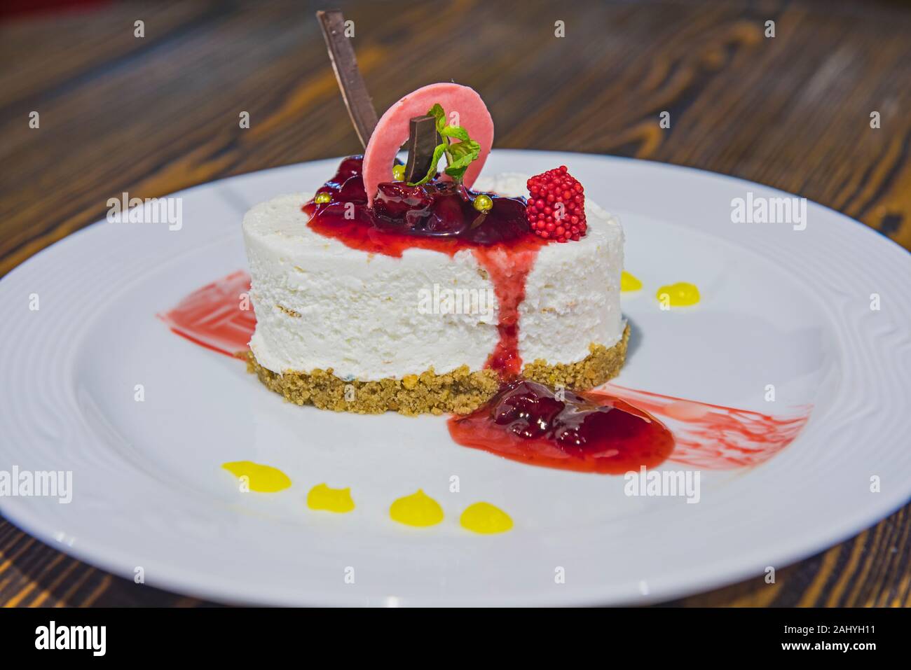 Raspberry cheesecake dessert food at luxury a la carte restaurant with sauce Stock Photo