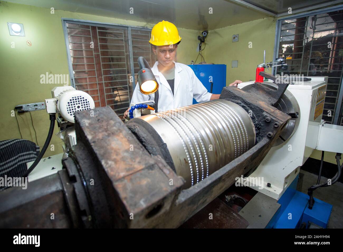 Bangladesh.A factory lab operator using Steel rod quality testing