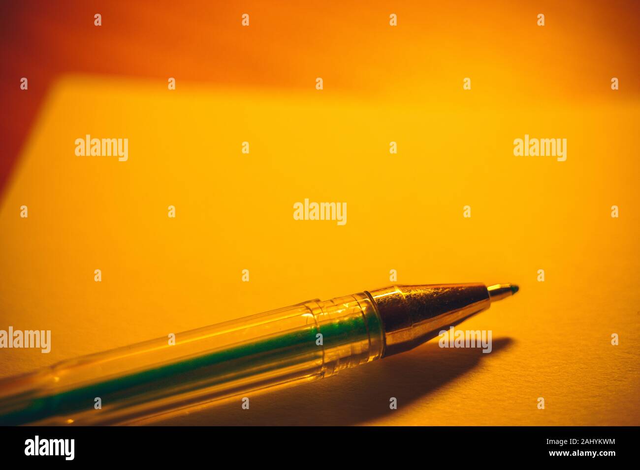 Gel pen on a notebook paper, accessory for creativity on the table. Stock Photo