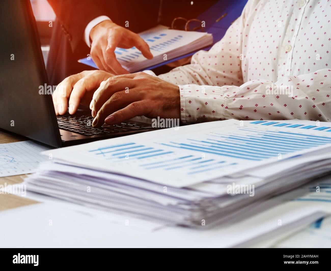 The manager advises the employee working at the computer. Audit and financial reporting. Stock Photo
