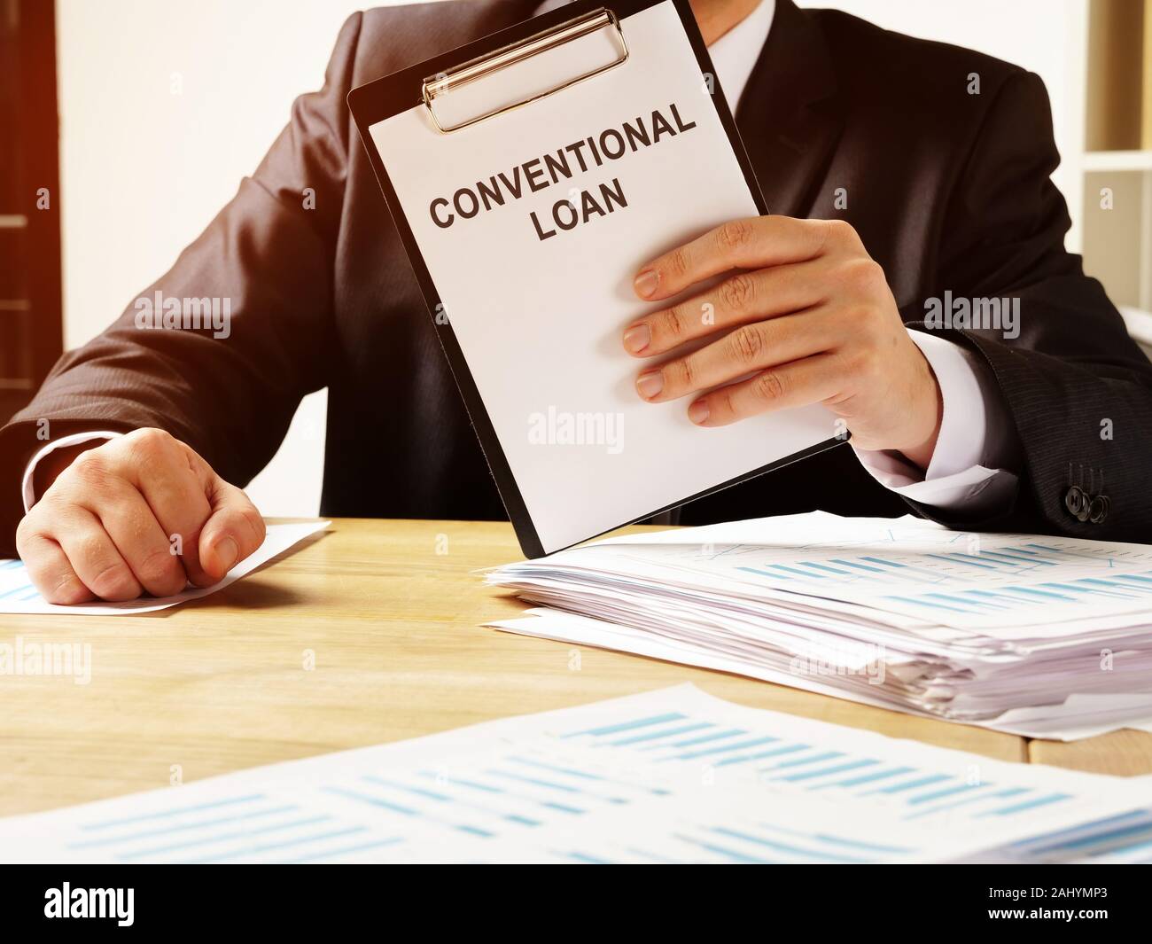 Manager holds Conventional loan agreement form. Stock Photo