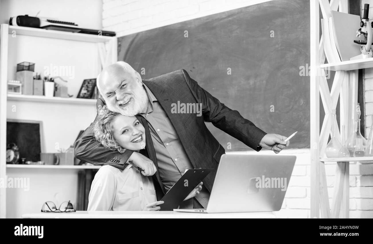 Happy student. brainstorming on new project working. pass exam. teachers room. happy student girl with tutor man at blackboard. student and tutor with laptop. senior teacher and girl at school lesson. Stock Photo