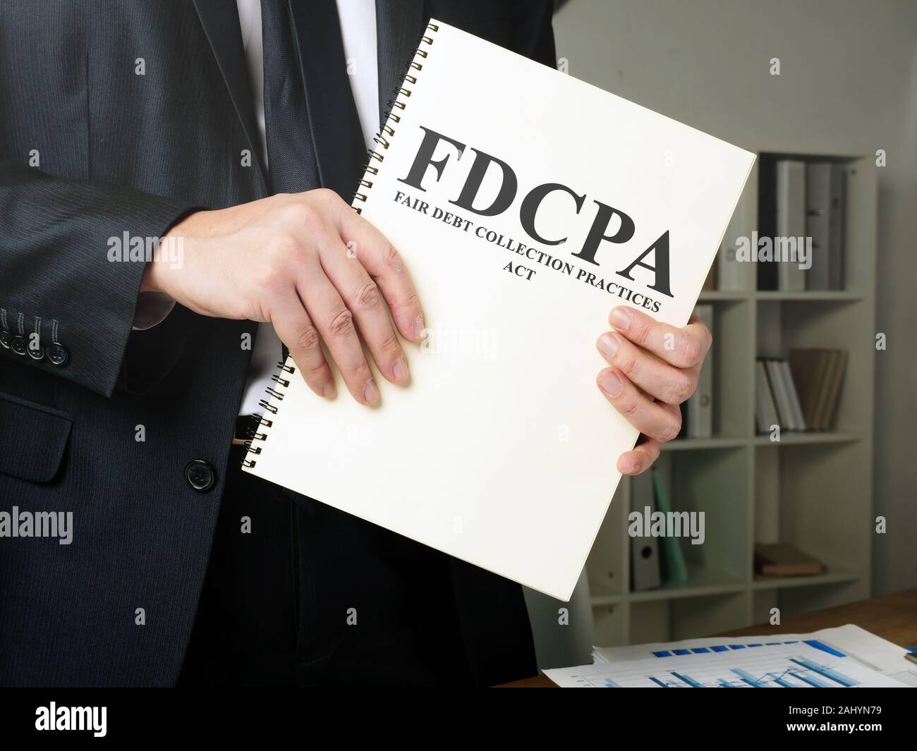 Man holds The Fair Debt Collection Practices Act FDCPA. Stock Photo