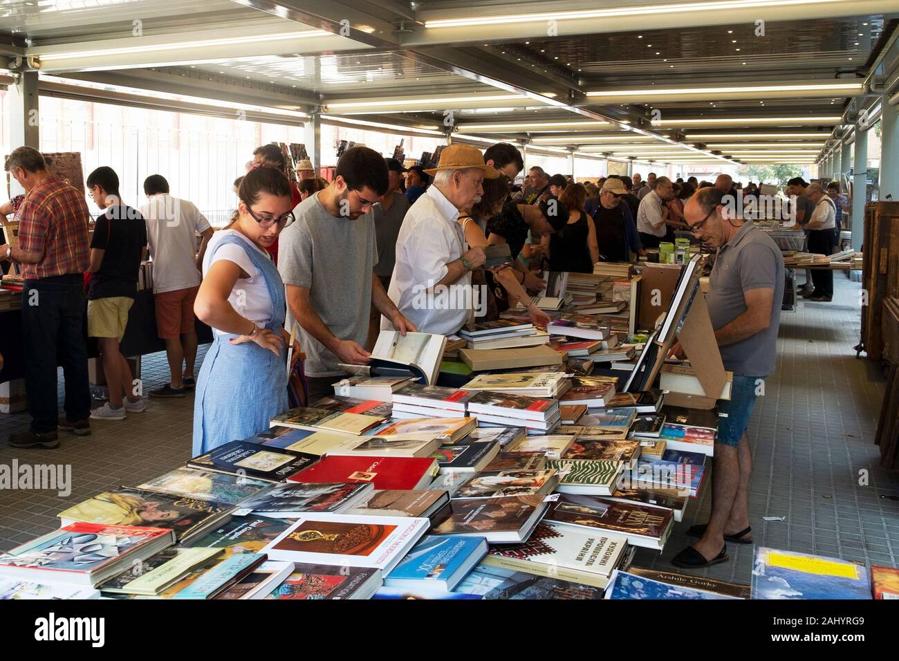 BARCELONA, SPAIN - JULY 15, 2018: Customers at the stalls of the secondhand book market at the Mercat de Sant Antoni public market in Barcelona, Spain Stock Photo
