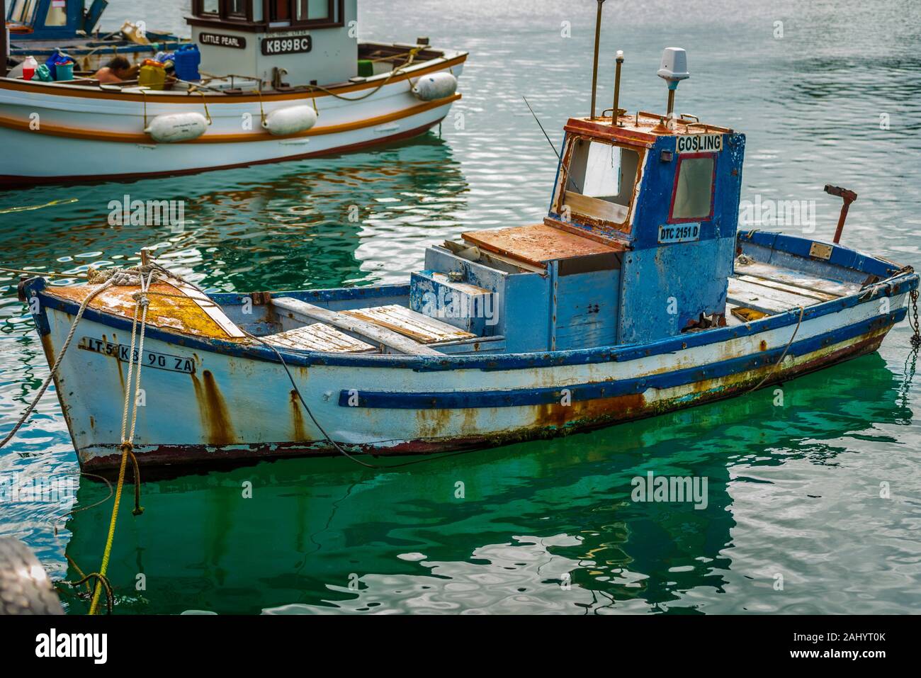 Old wooden-hulled handline fishing boat in need of repair. At her moorings,  Kalk Bay Harbour, CApe Town Stock Photo - Alamy