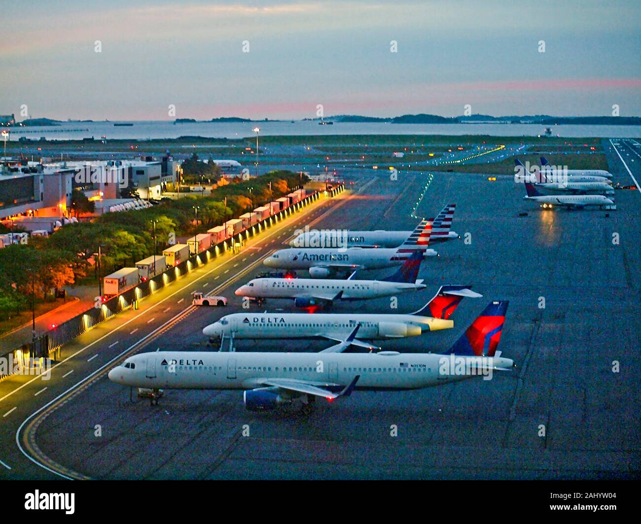 Overnight aircraft parking at Logan International Airport in Boston. Massachusetts. Note the cue of Fedex trucks linned up at left of screen. Stock Photo