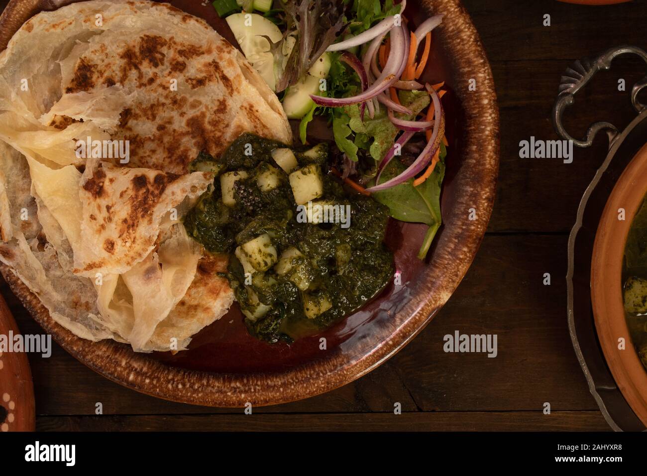 Saag Aloo Indian potato and spinach burry served with flaky layered