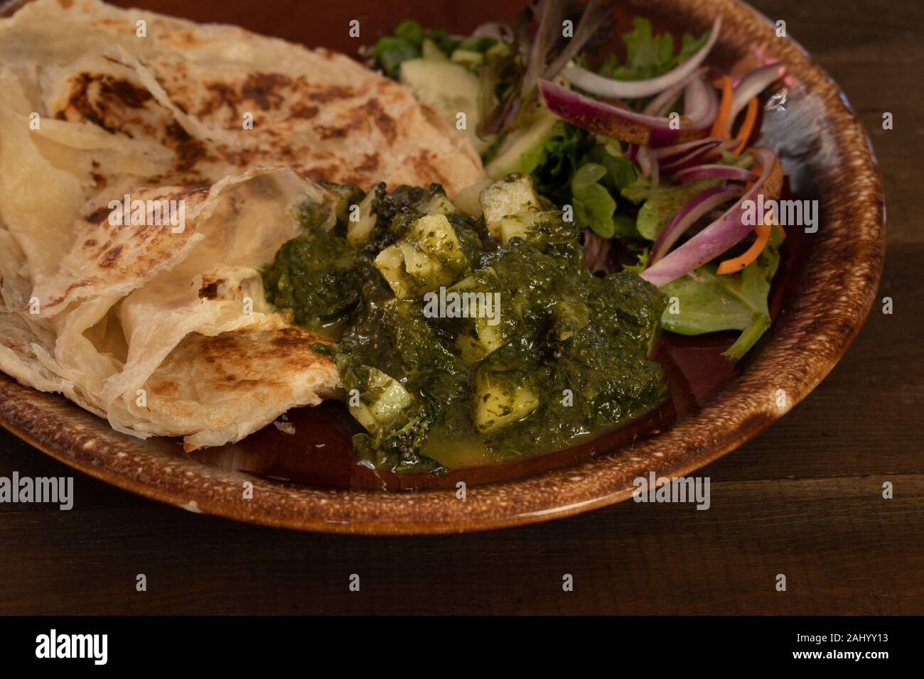 Saag Aloo Indian potato and spinach burry served with flaky layered