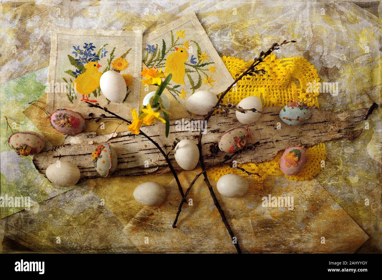 Easter eggs and Easter decorations spread out on grungy cloth.  Horizontal image with digital texture layer. Stock Photo