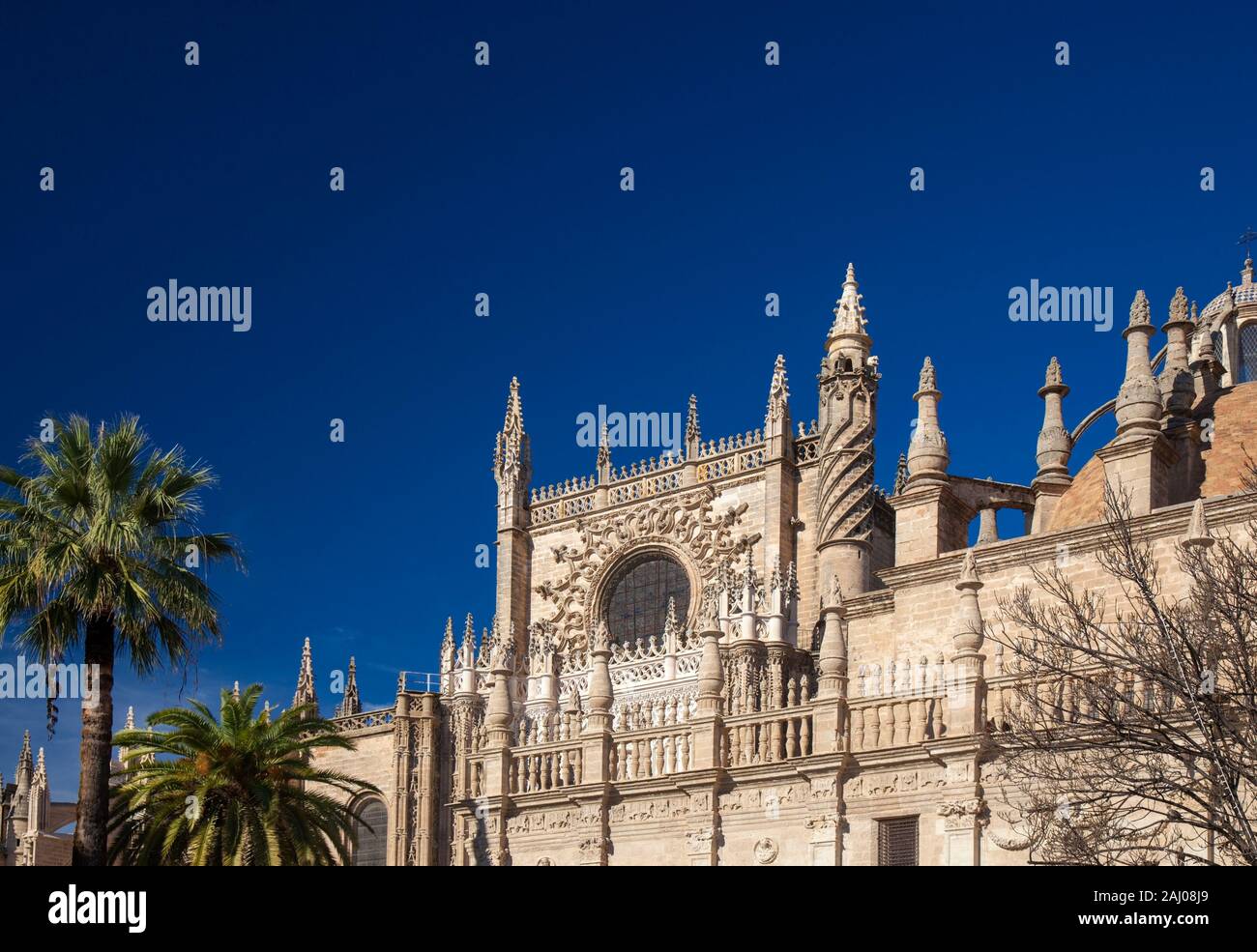 Seville Cathedral against background of deep blue sky, central rose window Stock Photo