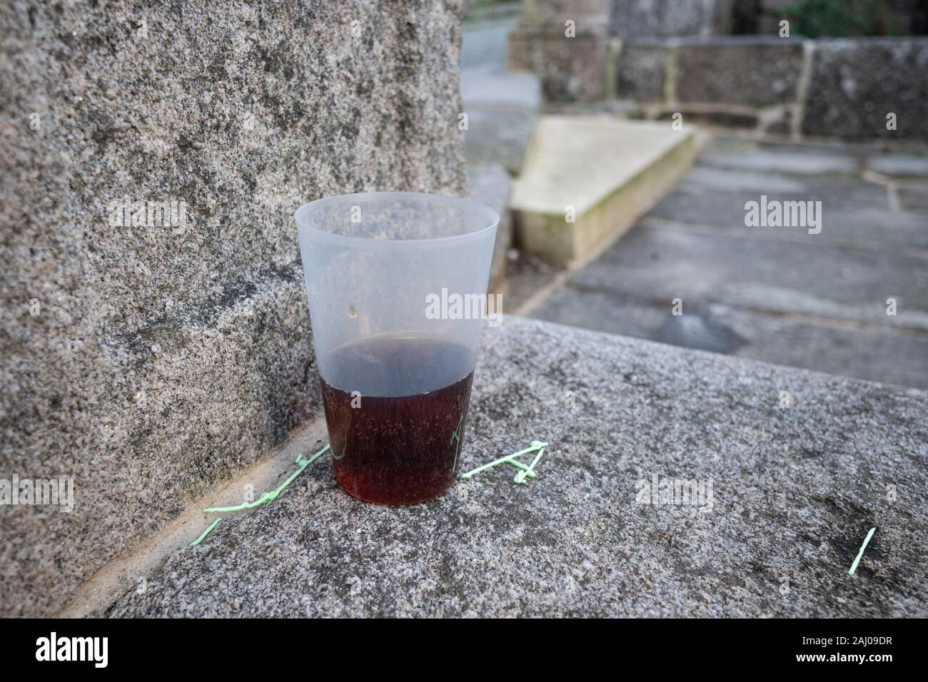 Abandoned plastic glass with coke drink after the party. Outdoor Stock Photo