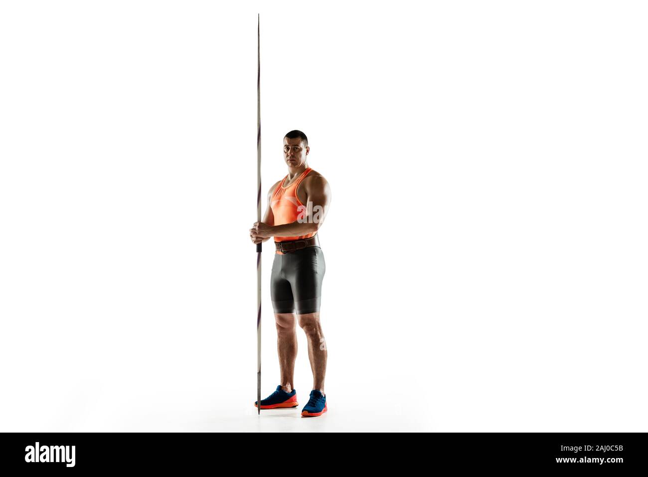 Male athlete practicing in throwing javelin isolated on white