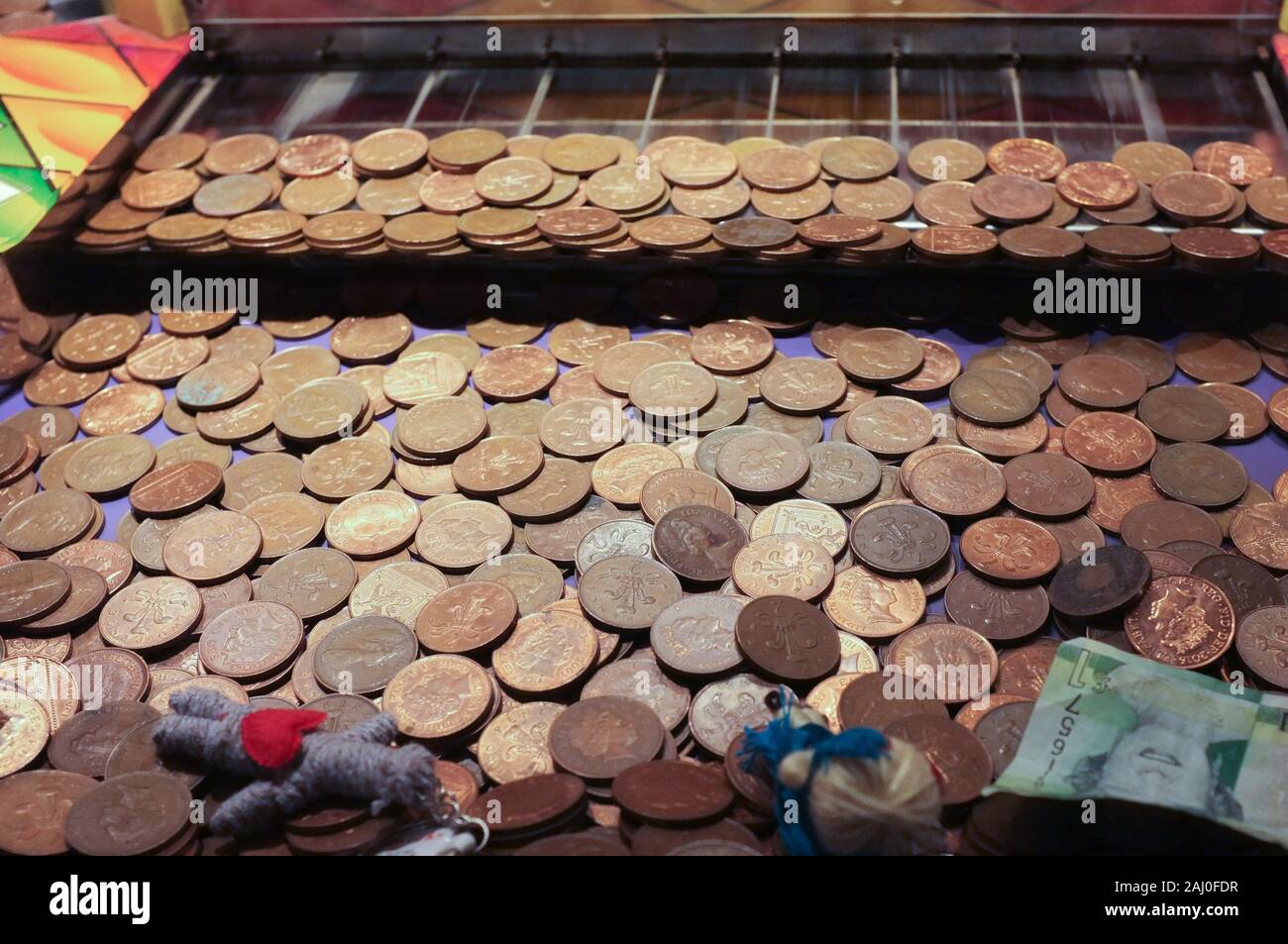 English coins on an arcade game in a travelling fair in 2018. Stock Photo