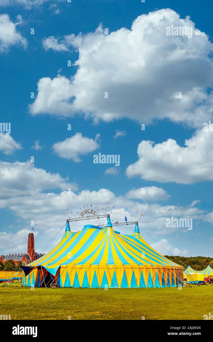 Vertical view of a circus tent under a warn sunset and chaotic sky Stock Photo