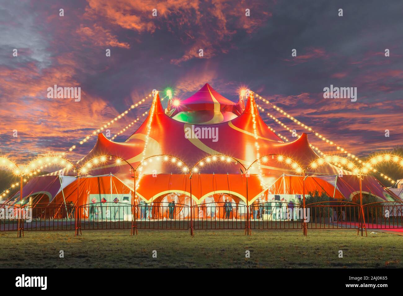 Night view of a circus tent under a warn sunset and chaotic sky Stock Photo