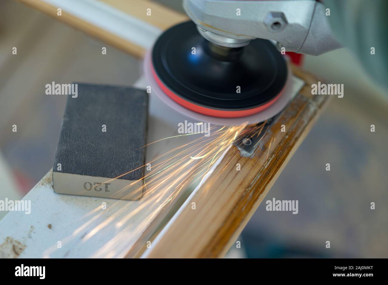 An electrical tool that polis the corner of old wooden frame for