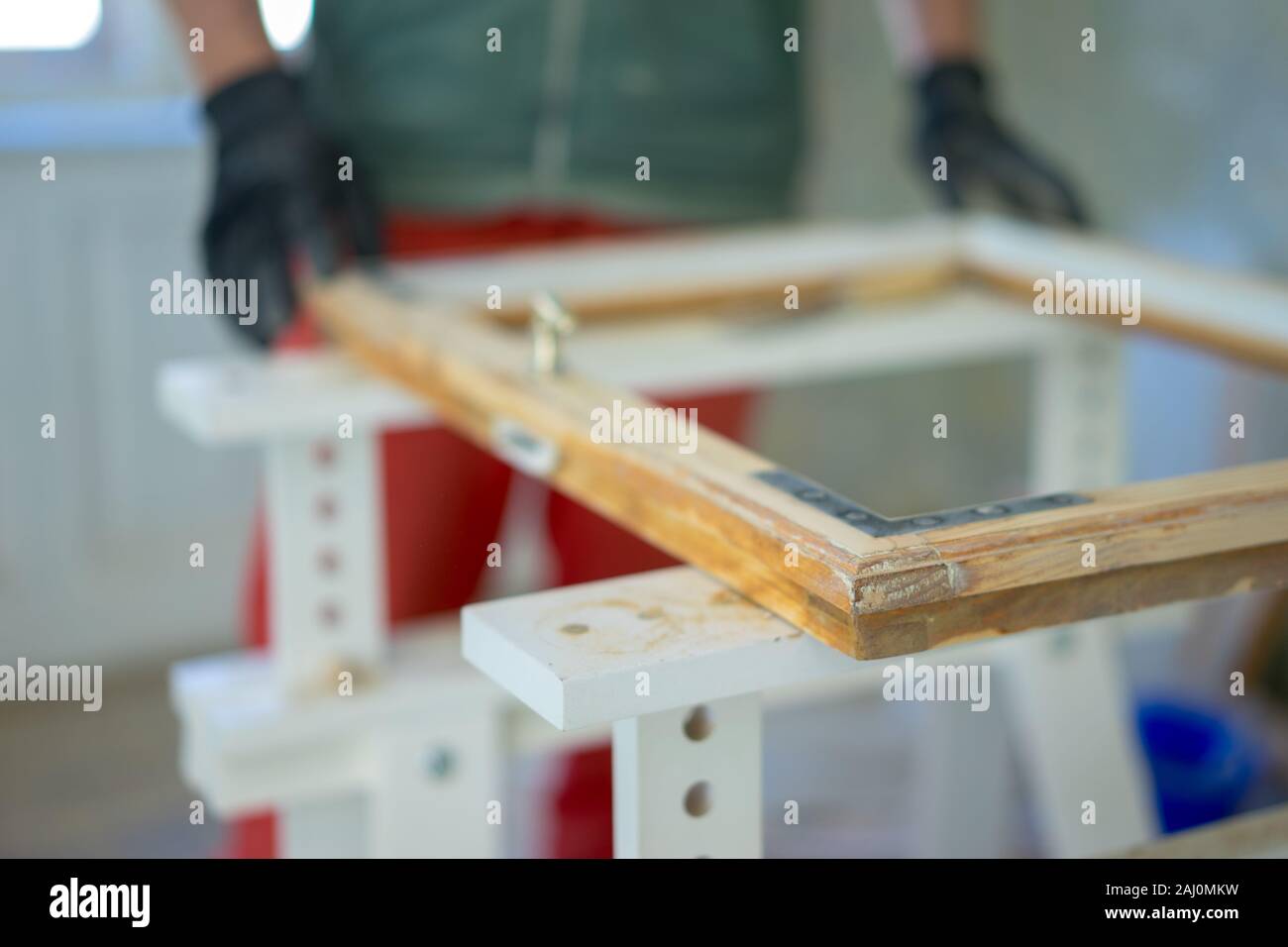 Man fix an old frame window, get ready for painting Stock Photo Alamy