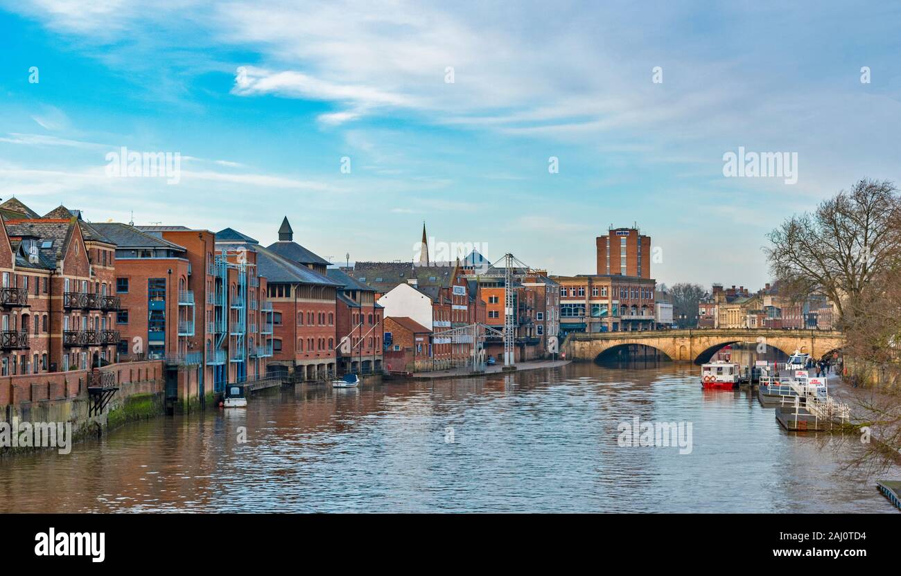 YORK ENGLAND VIEW DOWN THE RIVER OUSE PAST WOODSMILL AND OTHER OLD WAREHOUSES TO THE OUSE BRIDGE Stock Photo