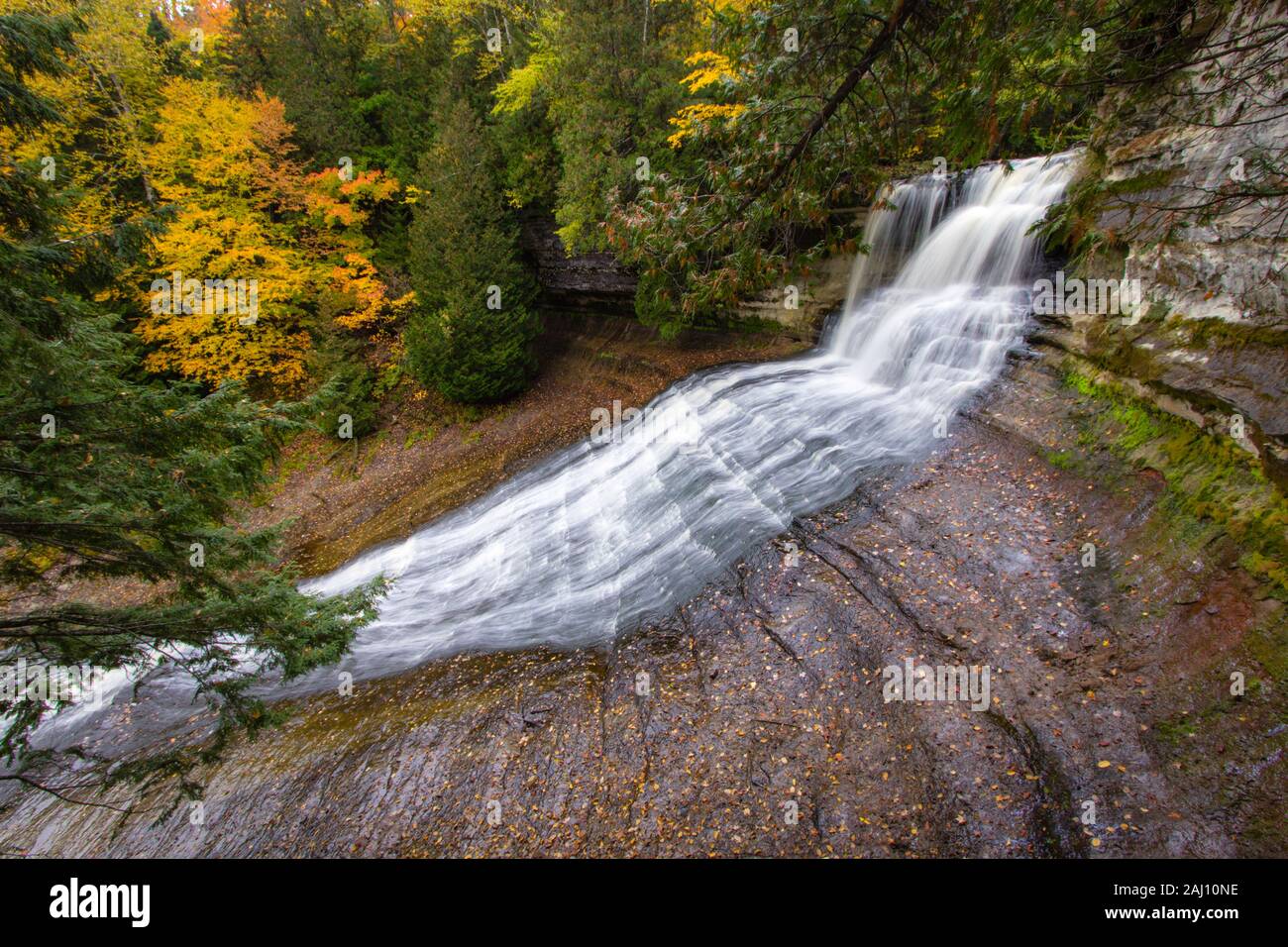 Autumn Michigan Waterfall. Laughing Whitefish Falls Scenic Site surrounded by fall foliage in the Upper Peninsula of Michigan. Stock Photo