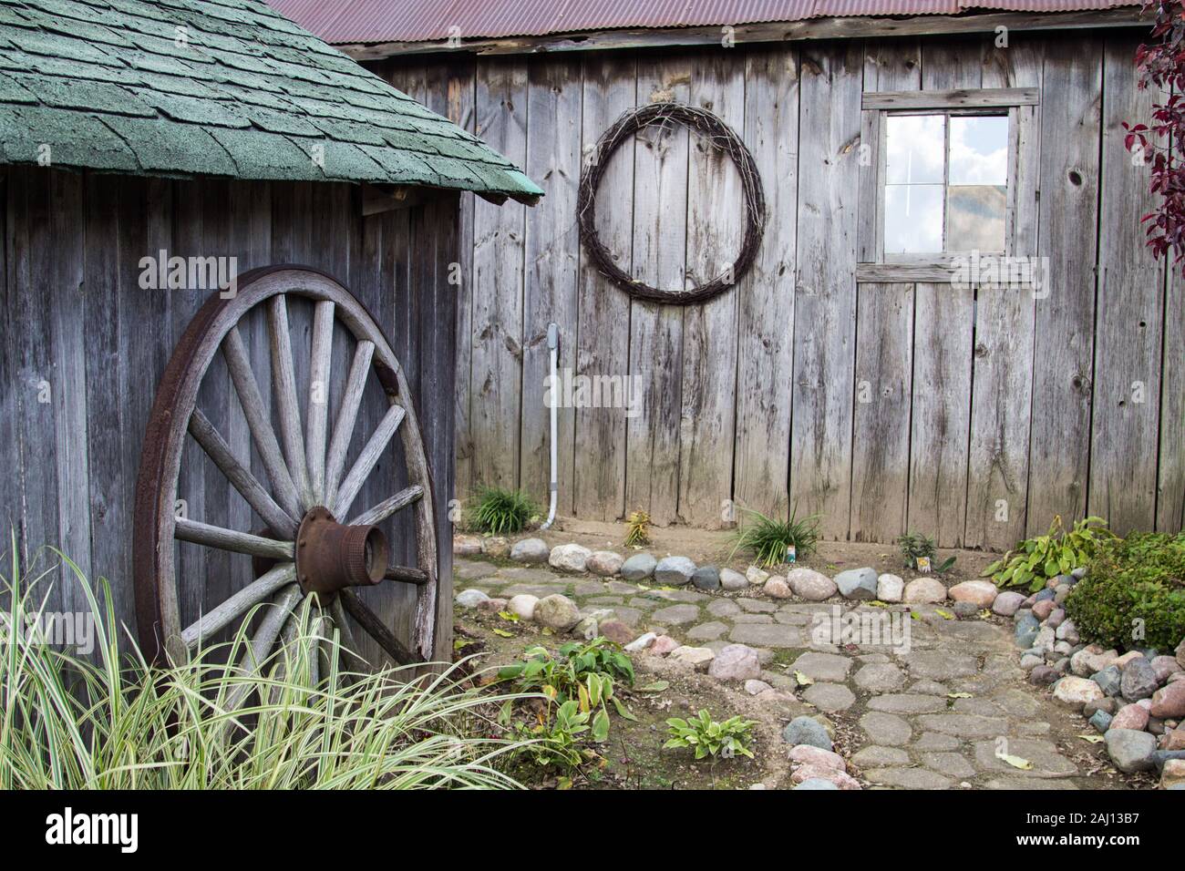 Country Garden Shed. Winding stone path among gardeners shed and outbuildings. Stock Photo