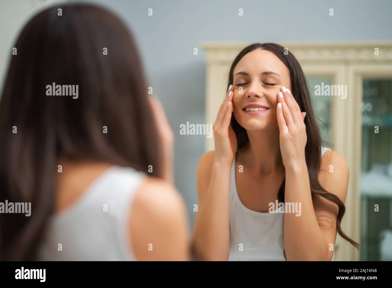 Beautiful woman enjoying her skin after successful skin treatment. Stock Photo