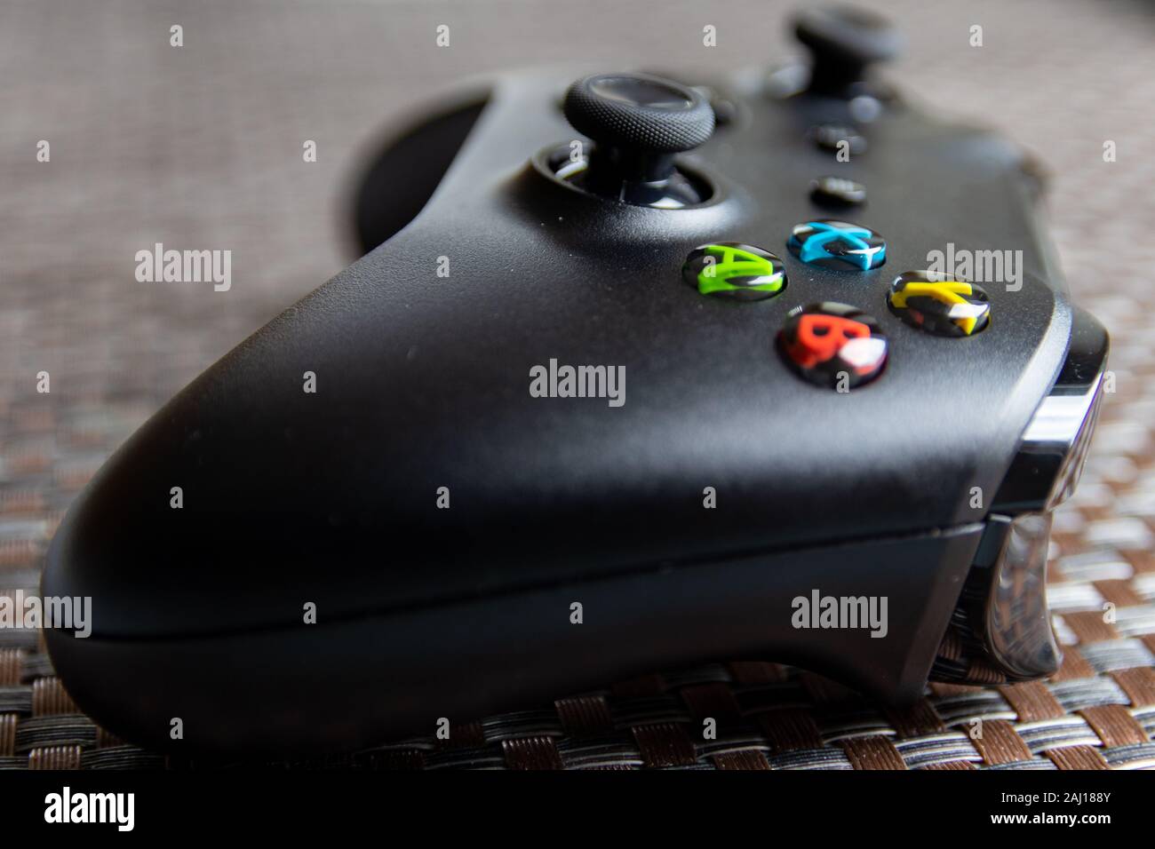 No brand black game controller on textured surface Stock Photo