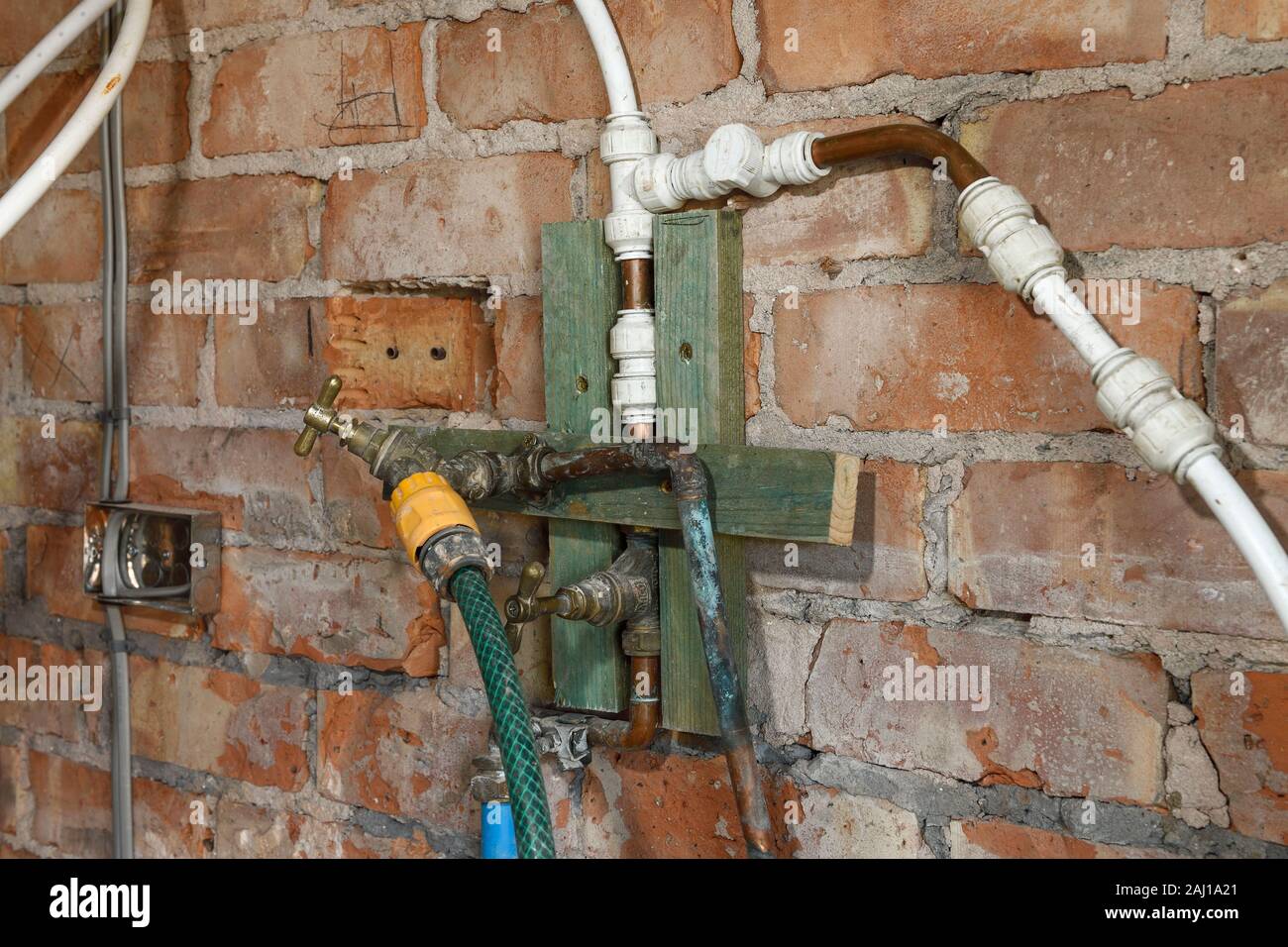 A complicated configuration of water pipes and taps on a UK building site Stock Photo