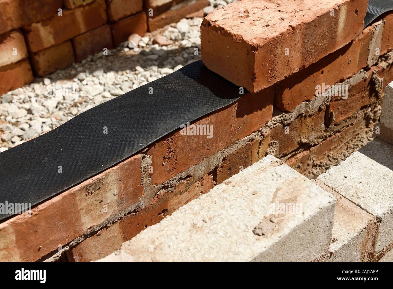 Close up detail of a cavity wall on a UK building site showing the damp proof course Stock Photo