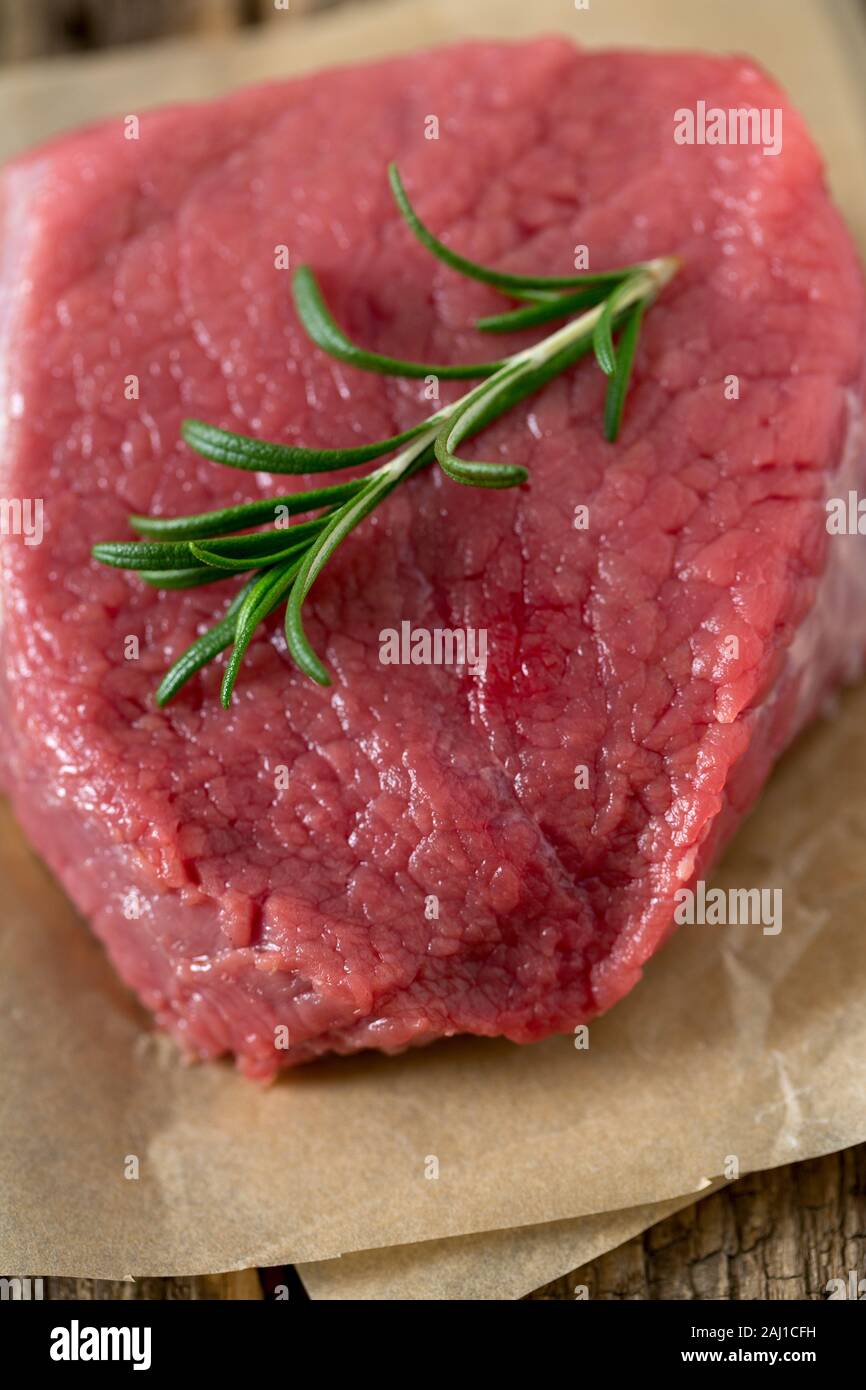 raw steak on wooden surface Stock Photo