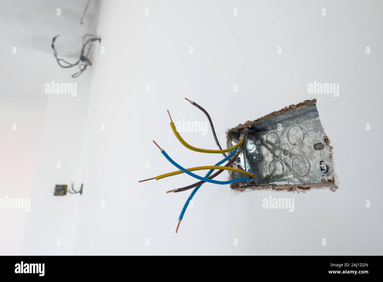 A first fix electrical socket in a freshly painted white wall Stock