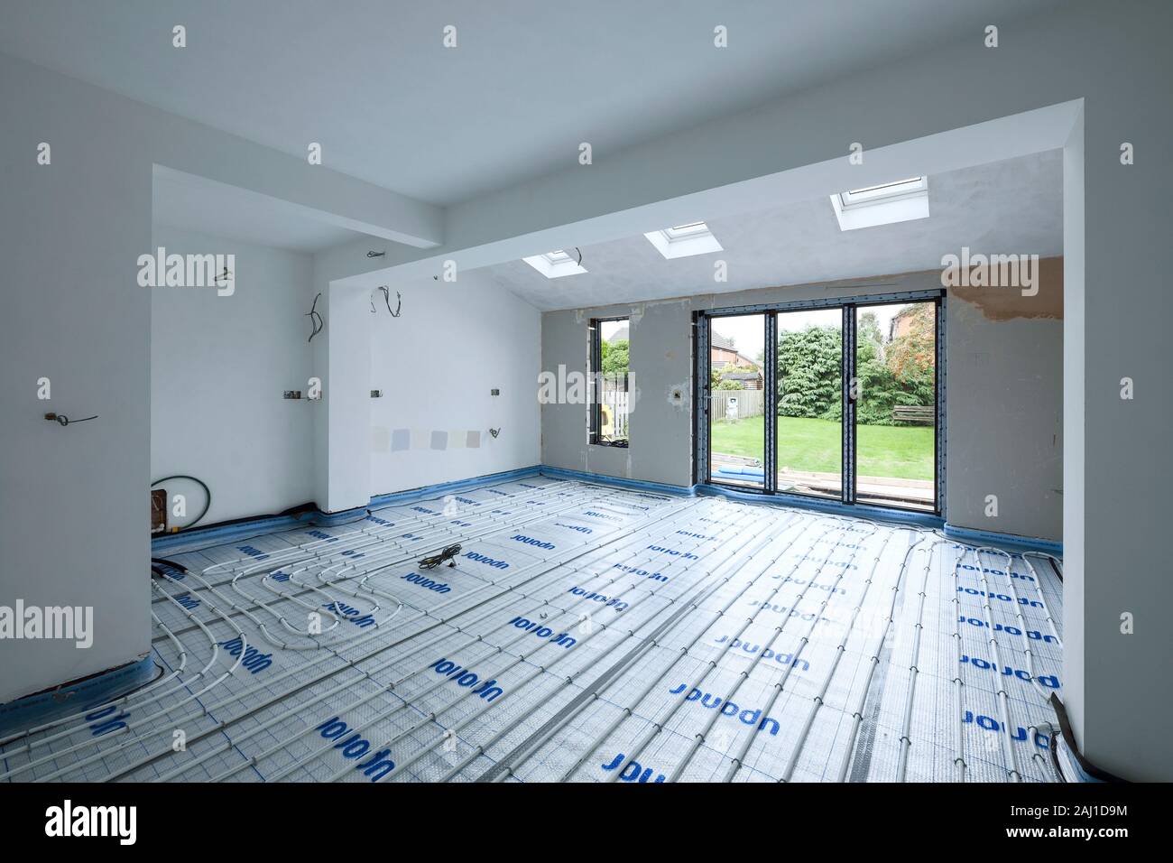 Exposed underfloor heating pipes in a rear extension project at a house in Cheshire UK Stock Photo