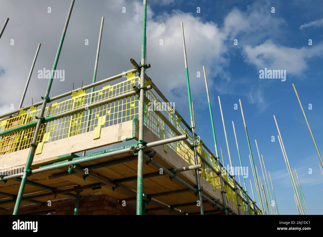 Close up detail of scaffolding with brick guards and toe boards on a UK