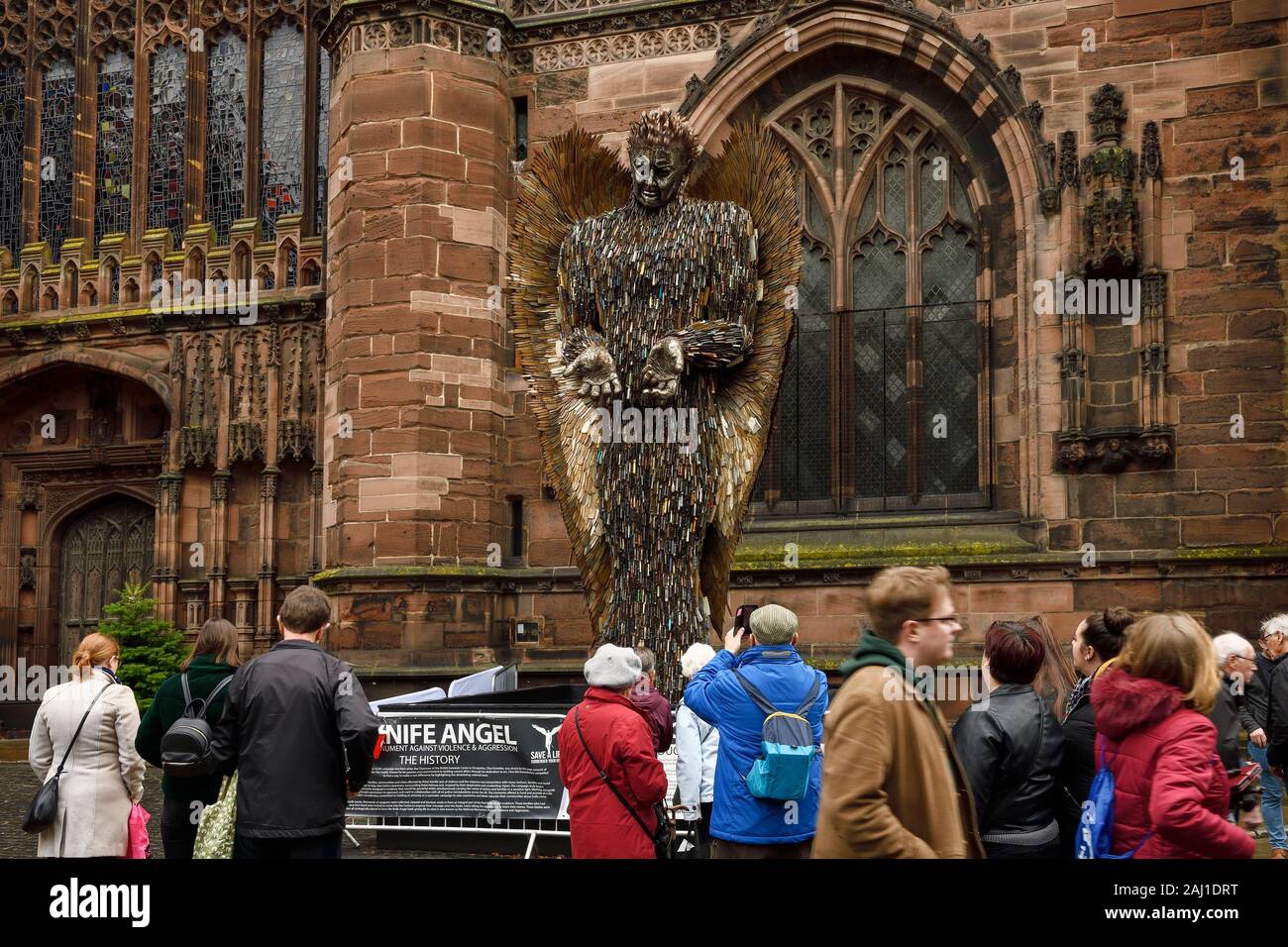 People looking at the Knife Angel sculpture by Alfie Bradley outside Chester Cathedral during November 2019 Stock Photo