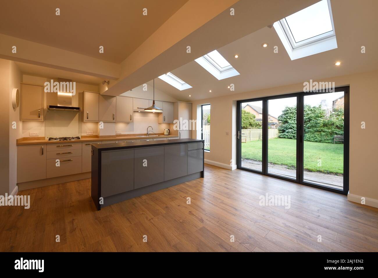 A modern open plan kitchen dining living room rear extension to a property in Chester with bifold doors and velds skylights Stock Photo