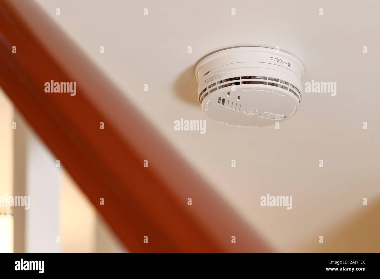 A mains wired smoke alarm fitted in a UK domestic property Stock Photo