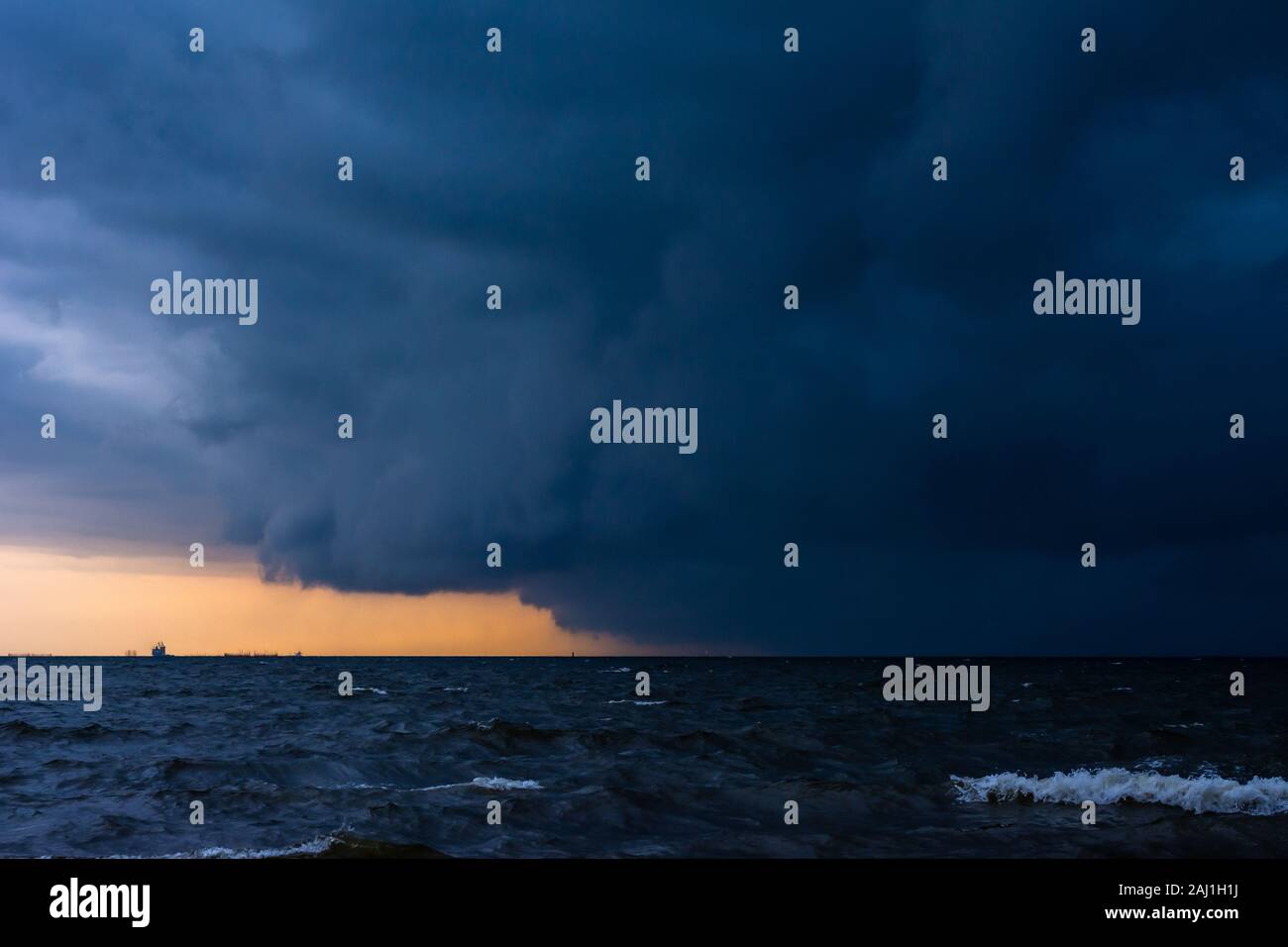 Approaching storm cloud with rain over the sea. Stock Photo