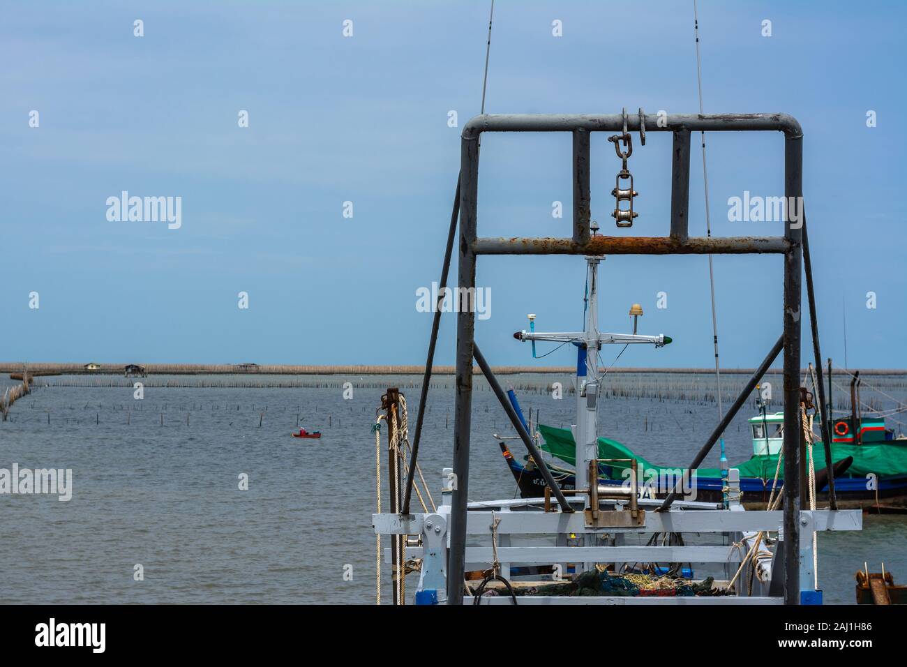 Fishing boat anchored in the harbor. Stock Photo
