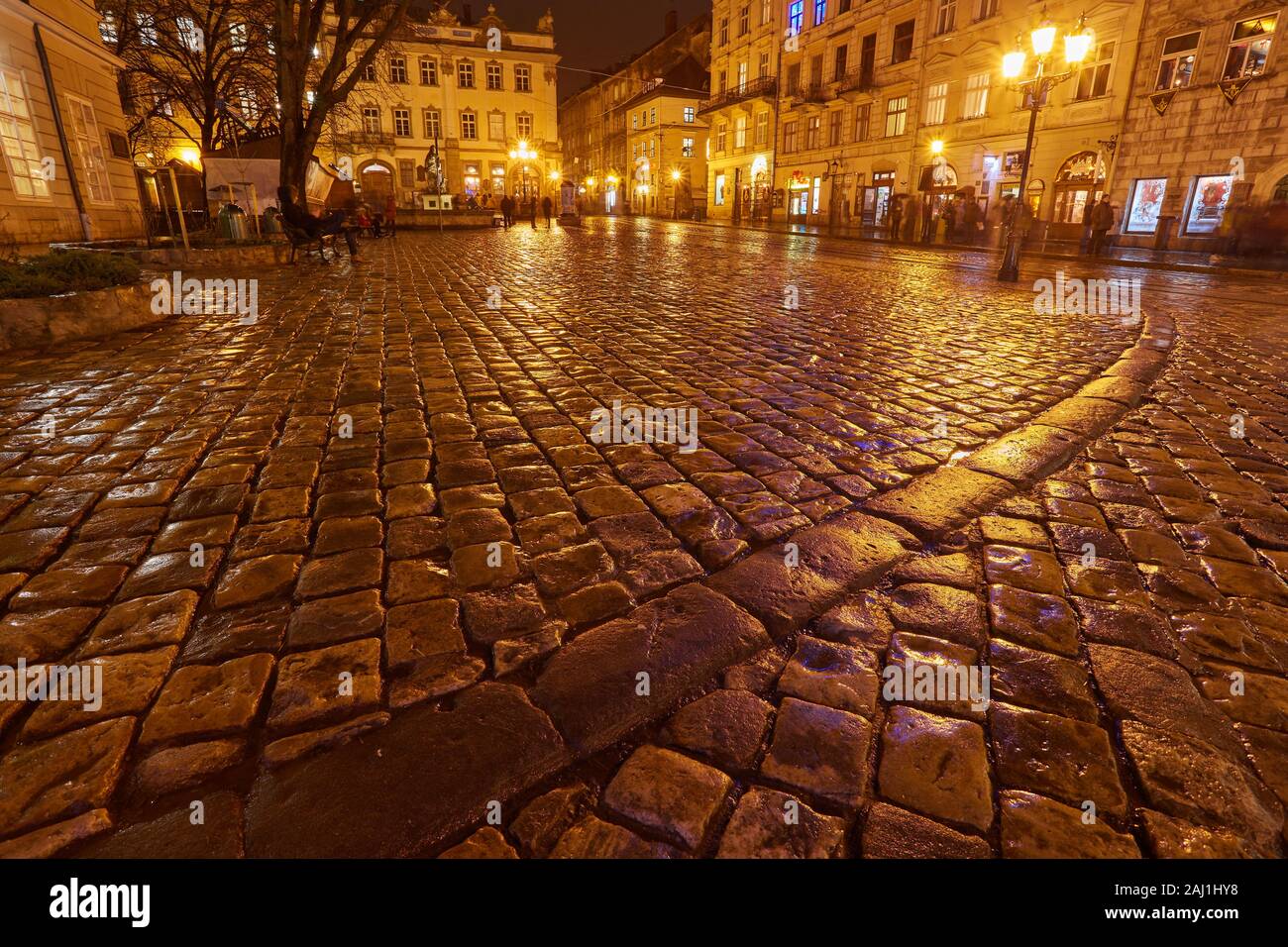 Mysterious narrow alley with lanterns in an old European city at night ...