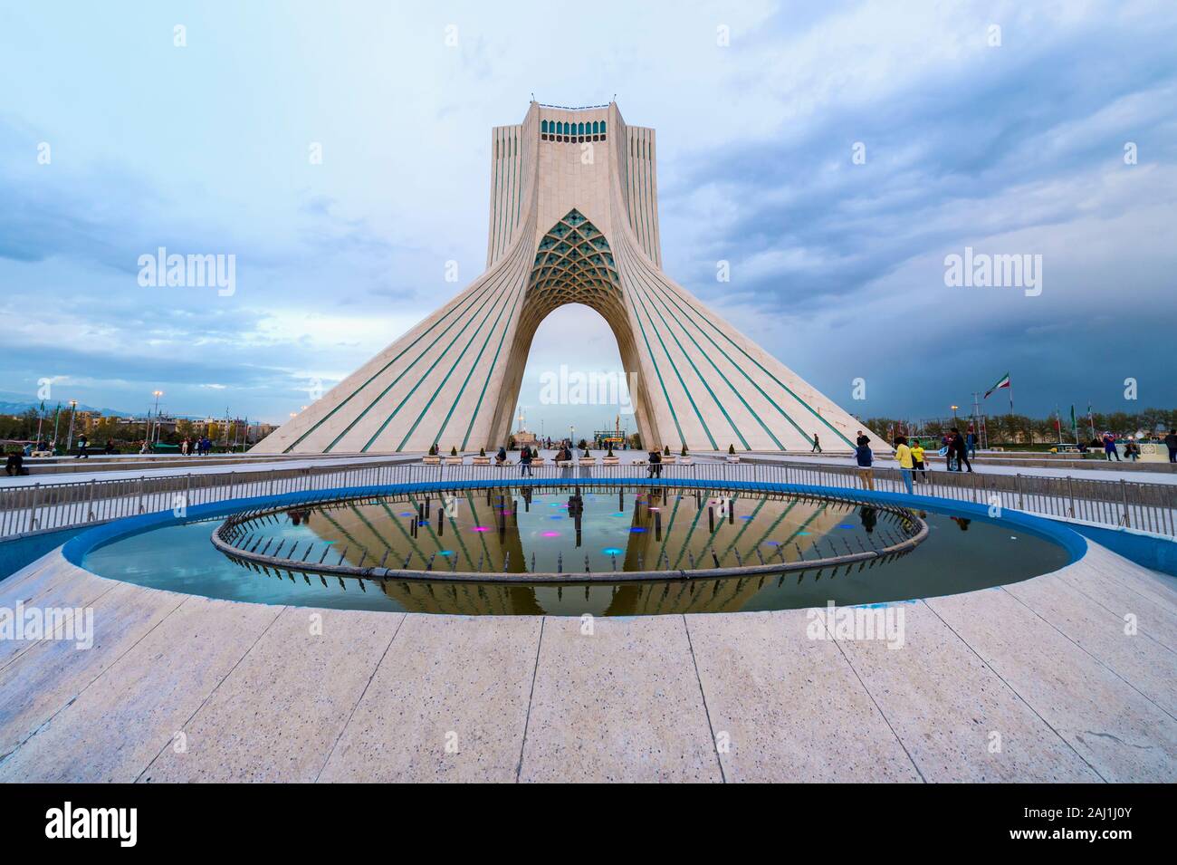Azadi Tower or Borj-e Azadi tower or Freedom Monument formerly known as Shahyad Tower and cultural complex reflecting in a pond, Tehran, Islamic Repub Stock Photo
