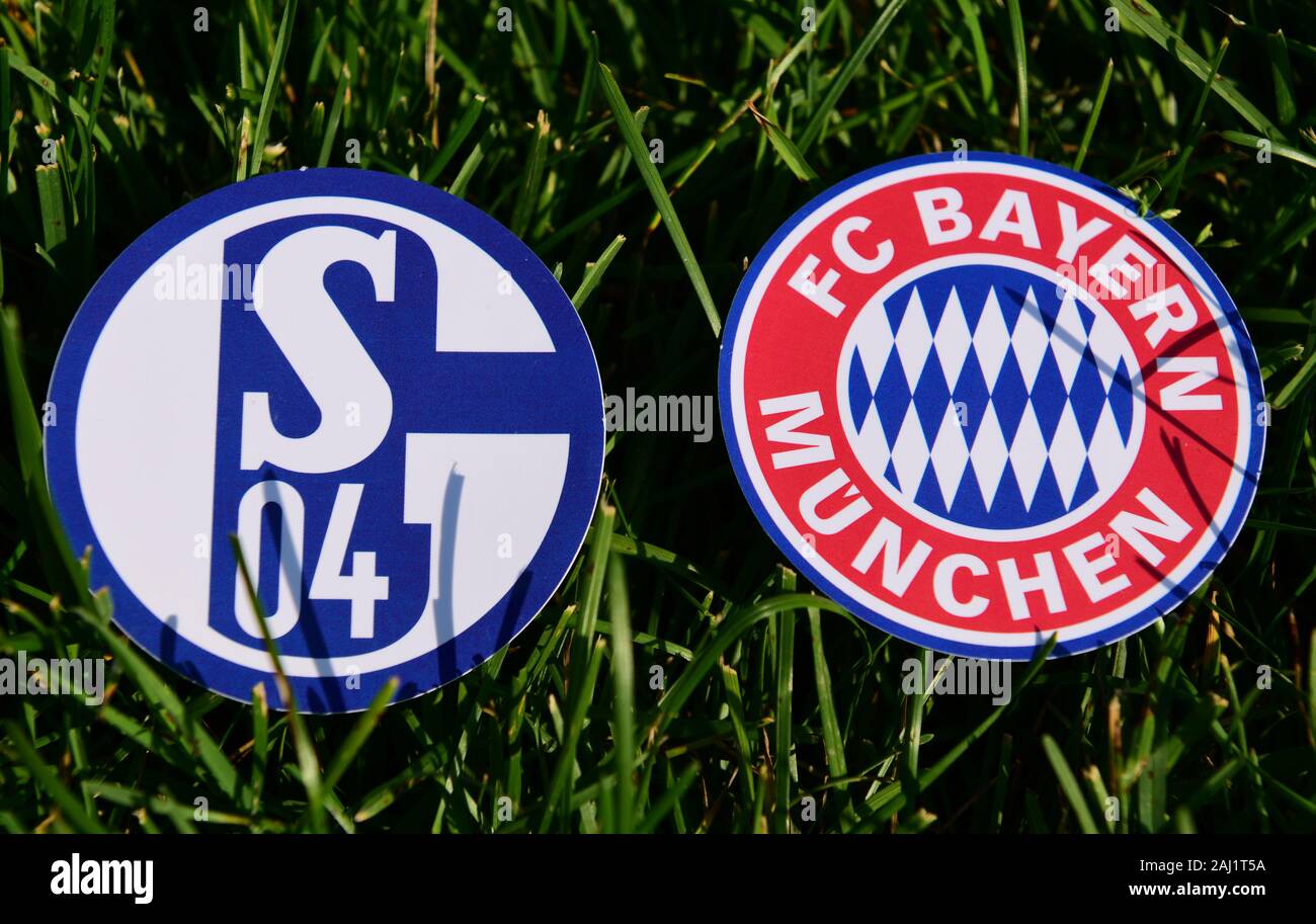 September 6, 2019, Munich, Germany. Emblems of German football clubs Bayern Munich and Schalke 04Gelsenkirchen on the green lawn Stock Photo