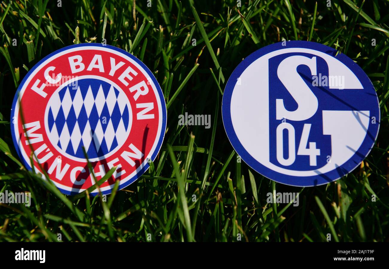 September 6, 2019, Munich, Germany. Emblems of German football clubs Bayern Munich and Schalke 04Gelsenkirchen on the green lawn Stock Photo
